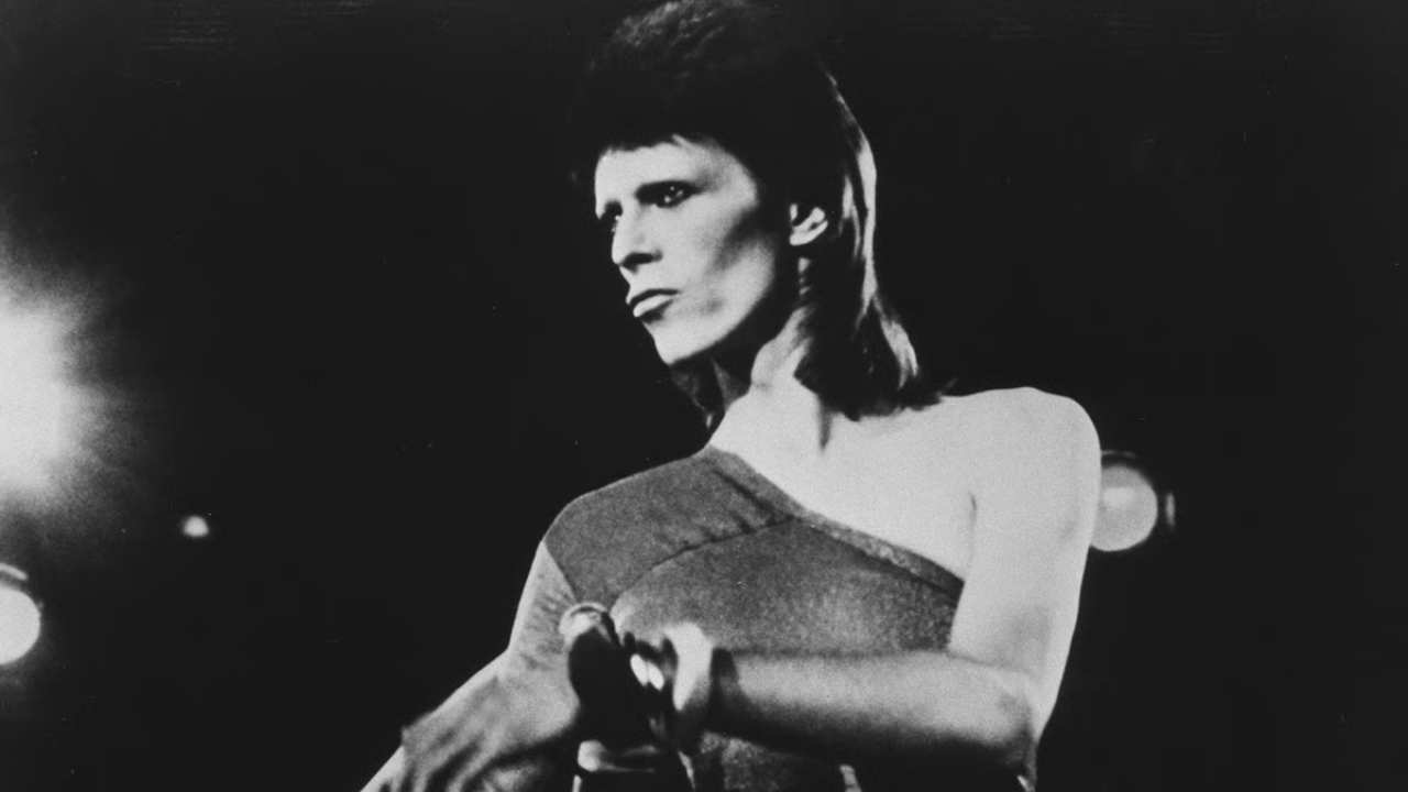 David Bowie holding a microphone